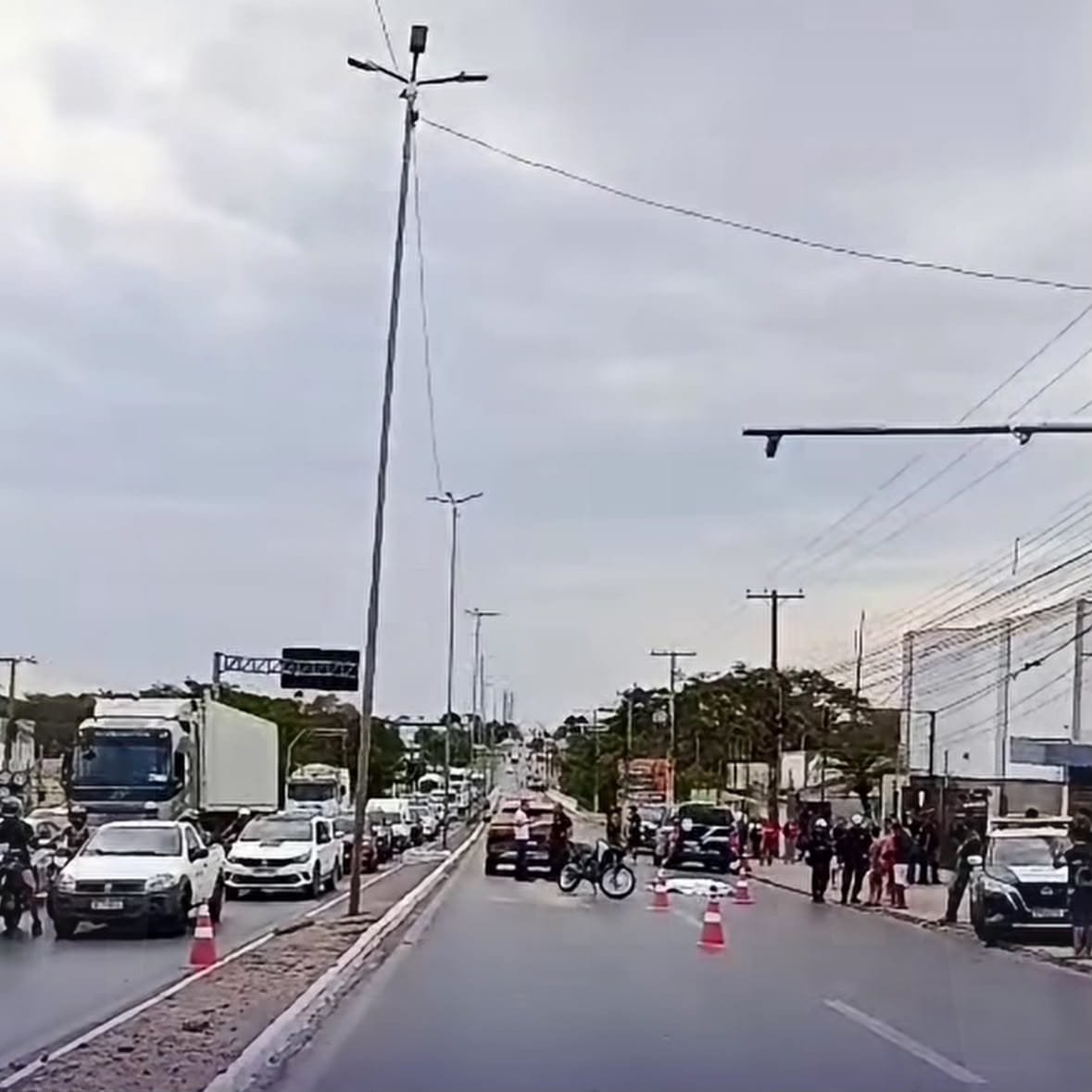 Filho ajoelhado em oração ao corpo do pai após atropelamento em Cuiabá